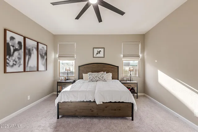 a bedroom with a bed and painting on the wall