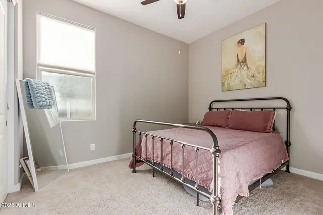 a bed sitting in a bedroom next to a window