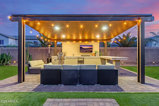 a view of a patio with couches and potted plants with wooden floor