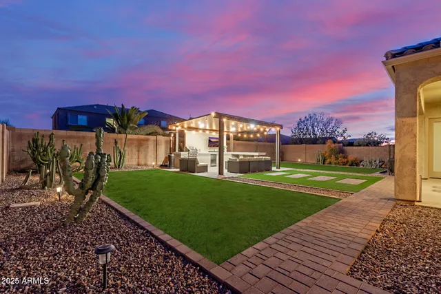 a view of a two chairs in a backyard