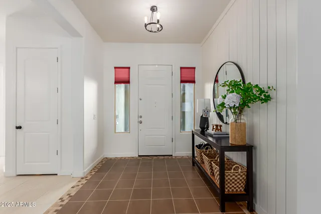 a hallway with a potted plant on a table and a potted plant
