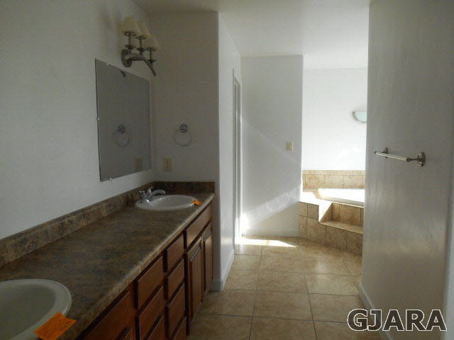 2264 L Road Grand Junction, CO 81505 - Photo 12 of 20 a bathroom with a granite countertop sink and a washing machine