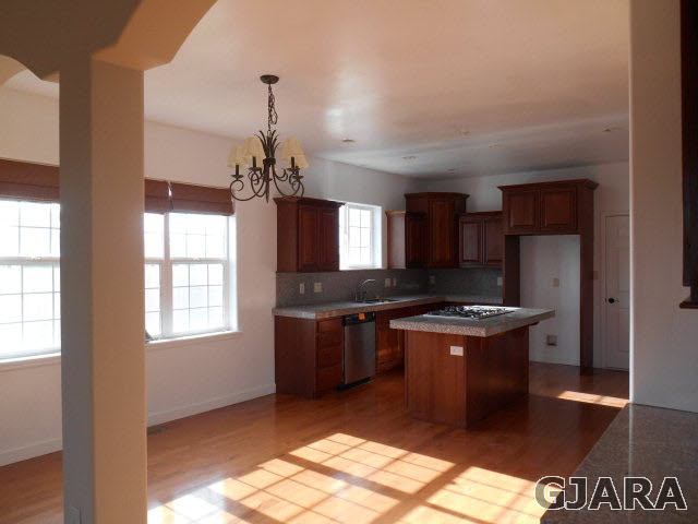 2264 L Road Grand Junction, CO 81505 - Photo 16 of 20 a kitchen with granite countertop a stove and a refrigerator