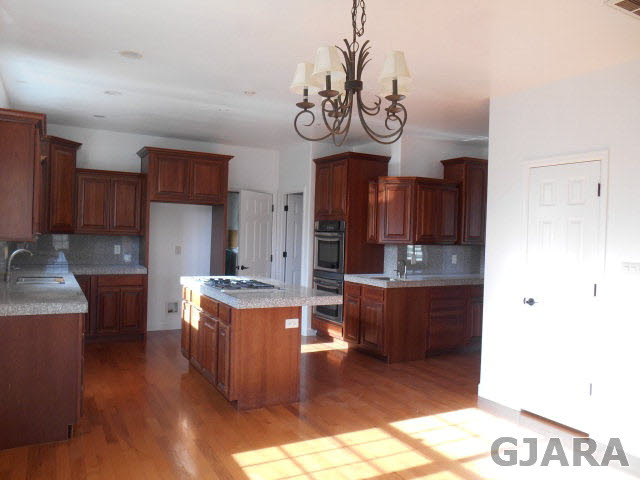 2264 L Road Grand Junction, CO 81505 - Photo 7 of 20 a kitchen with stainless steel appliances granite countertop a stove and cabinets