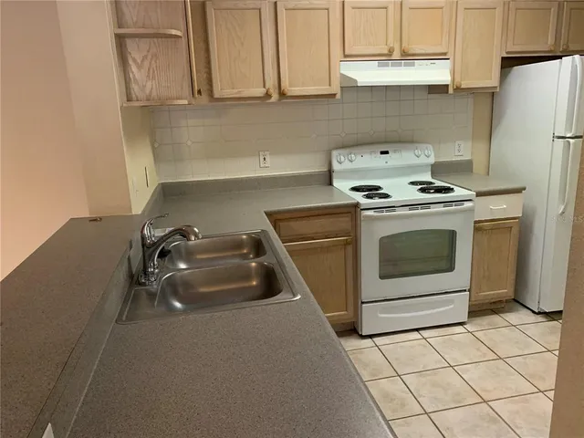 a kitchen with a stove and a sink