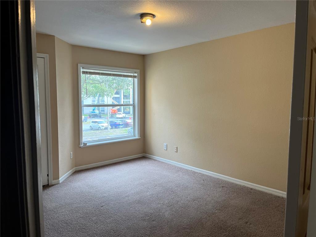 8800 Latrec Avenue, Unit 9203 Orlando, FL 32819 - Photo 5 of 8 a view of an empty room with a window