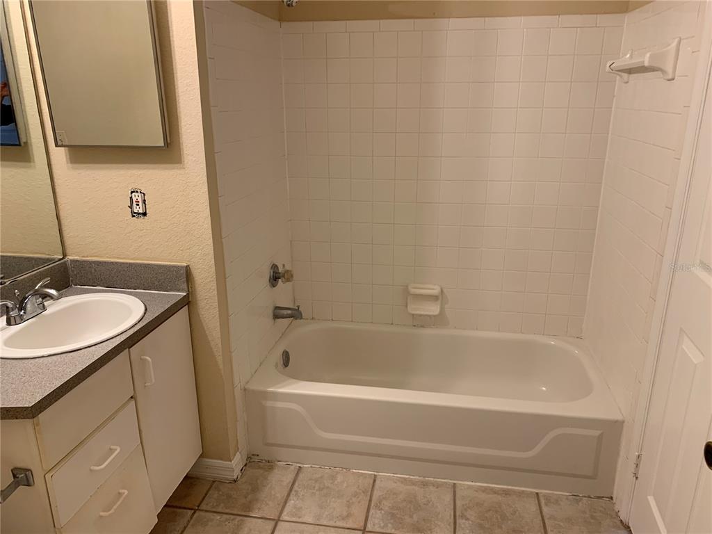 8800 Latrec Avenue, Unit 9203 Orlando, FL 32819 - Photo 6 of 8 a bathroom with a sink and a bathtub