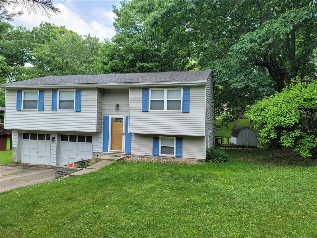 129 Crosslands Road Butler, PA 16002 - Photo 3 of 25 a brick house with a big yard and large trees