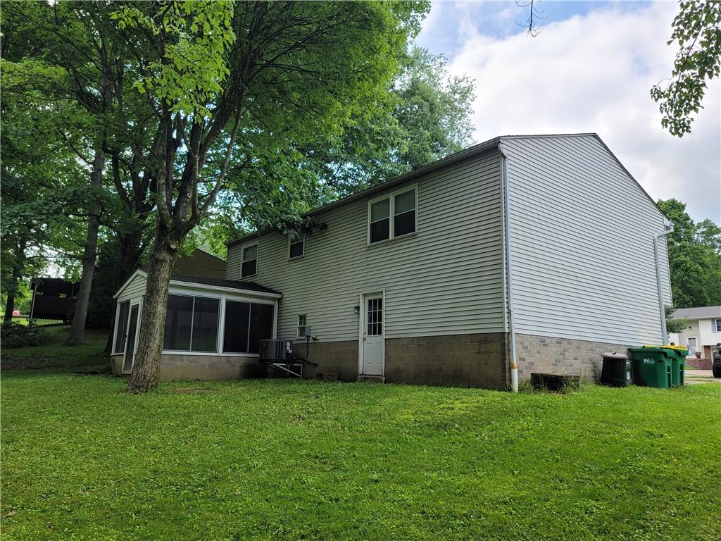 129 Crosslands Road Butler, PA 16002 - Photo 4 of 25 a backyard of a house with potted plants and large tree