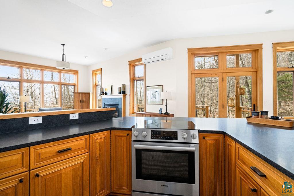 4856 Kingston Street Duluth, MN 55804 - Photo 14 of 88 Kitchen featuring a stainless steel range, dark countertops, and wood-finish cabinetry