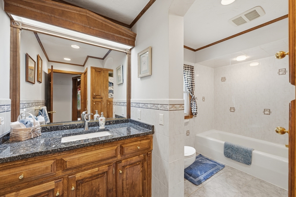 43 Flint Road Tyngsborough, MA 01879 - Photo 15 of 40 a bathroom with a granite countertop tub sink and mirror