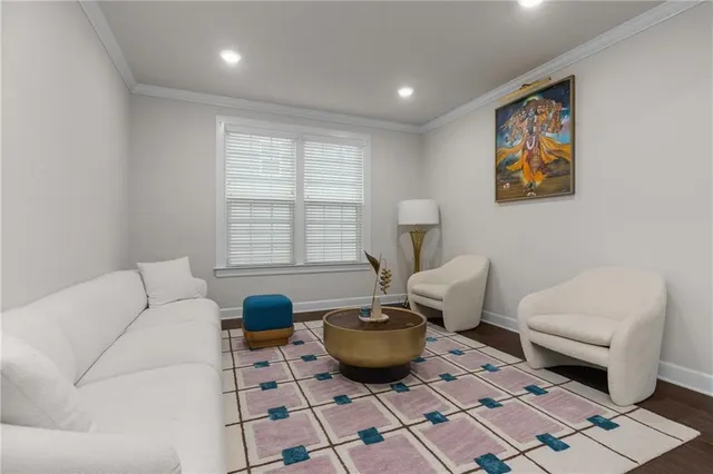 a living room with furniture a rug and a window