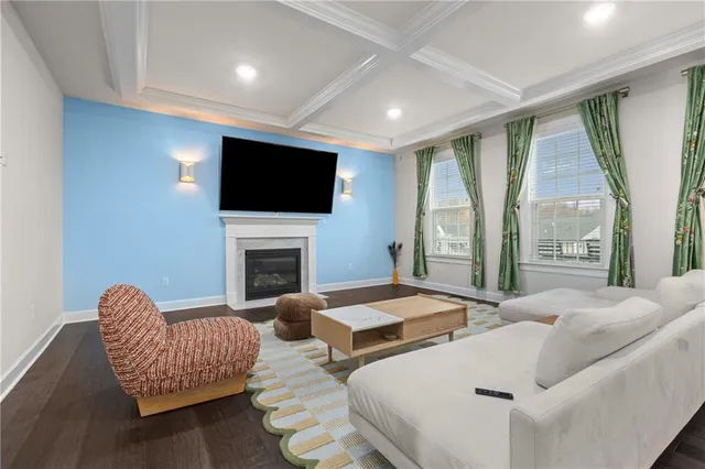 a living room with fireplace furniture and a flat screen tv