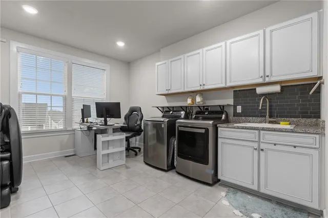 a kitchen with cabinets and chairs
