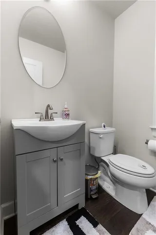 a bathroom with a sink toilet and a mirror