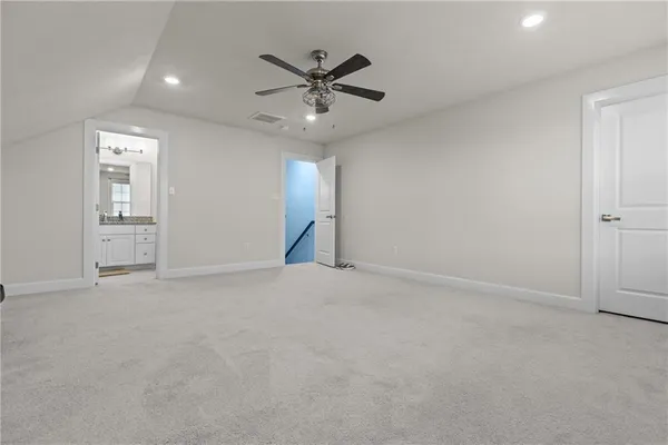 an empty room with closet and windows