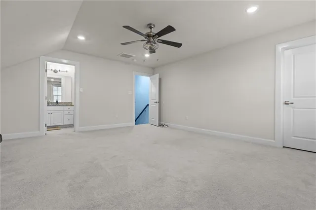 an empty room with closet and windows