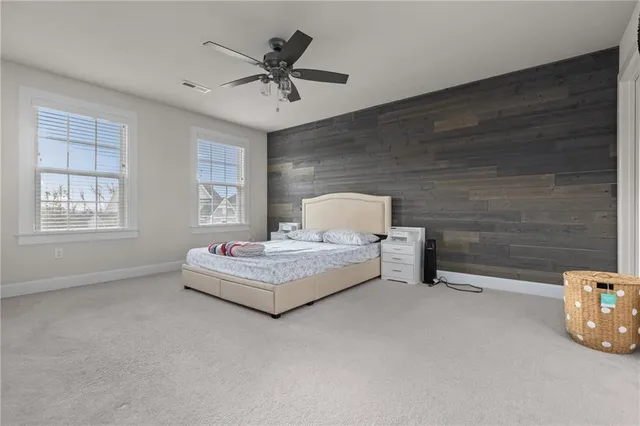 a spacious bedroom with a bed and window