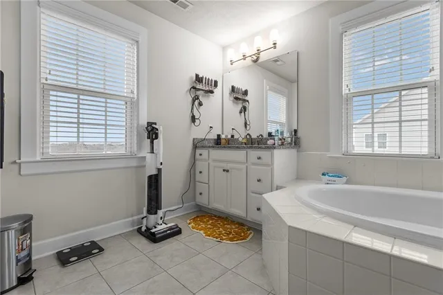 a bathroom with a tub sink and mirror