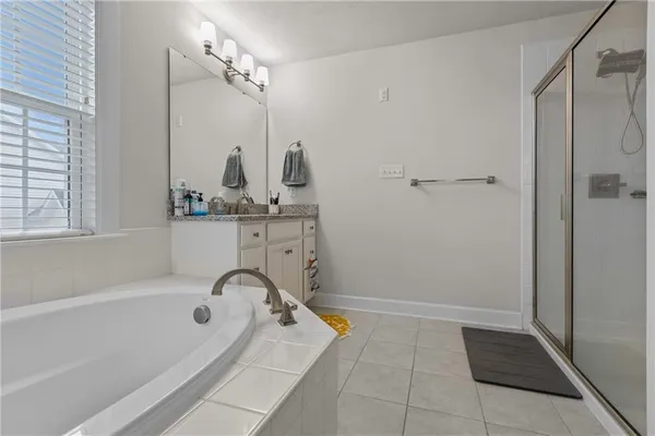 a bathroom with a tub sink and mirror
