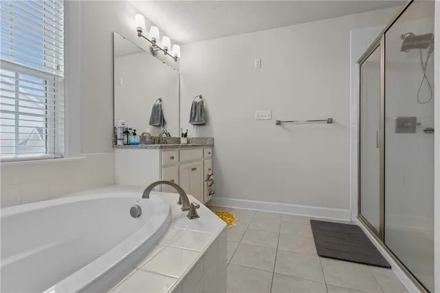 a bathroom with a tub sink and mirror