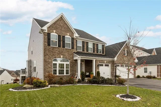 a front view of a house with a yard
