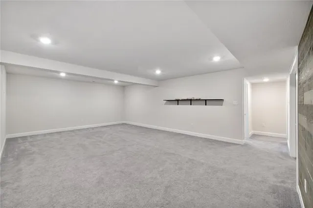 an empty room with a empty space and windows