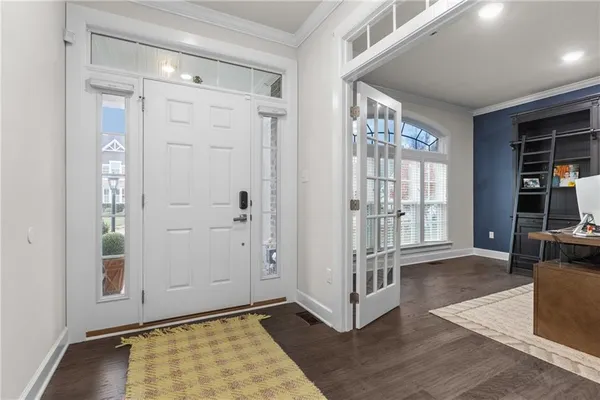 an empty room with wooden floor and a fireplace