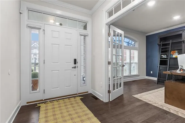 an empty room with wooden floor and a fireplace