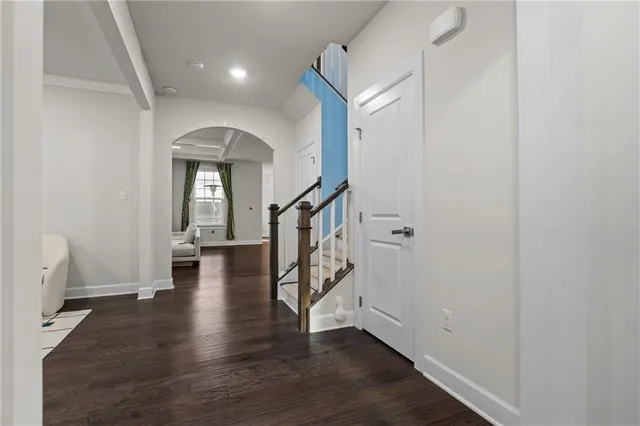 a view of entryway with wooden floor and stairs