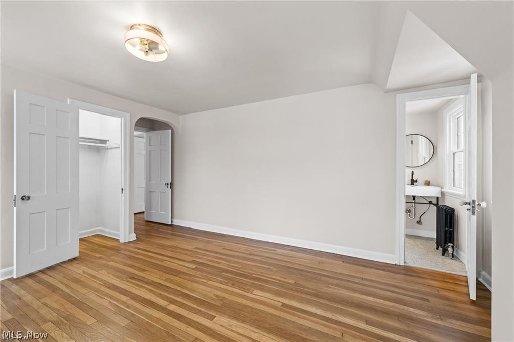 3145 Huntington Road Shaker Heights, OH 44120 - Photo 22 of 28 Spacious interior room featuring wood-finish flooring, white walls, and a semi-flush mount ceiling light