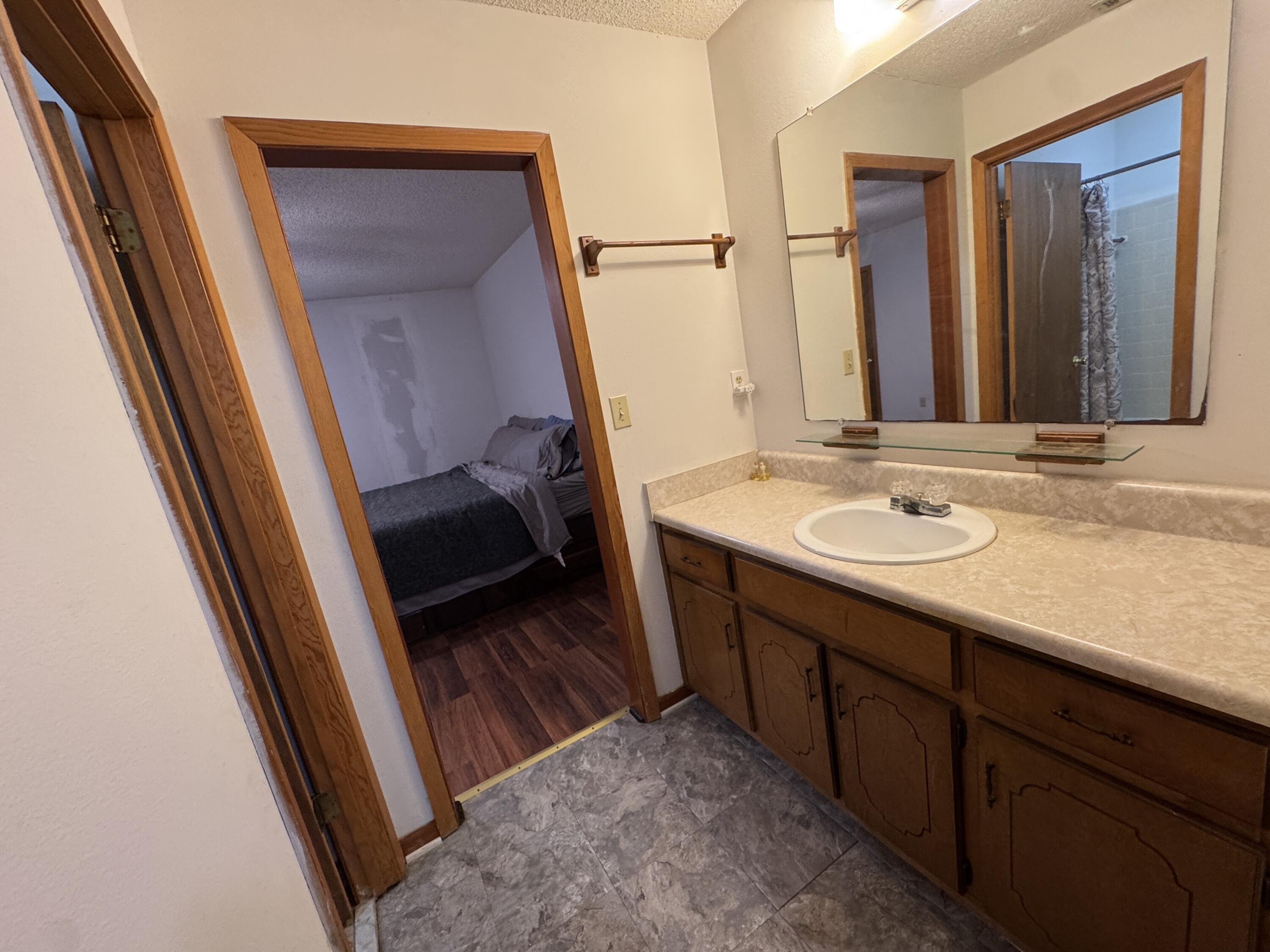 2928 Aplin Road Crestview, FL 32539 - Photo 12 of 42 a bathroom with a sink a mirror and a shower