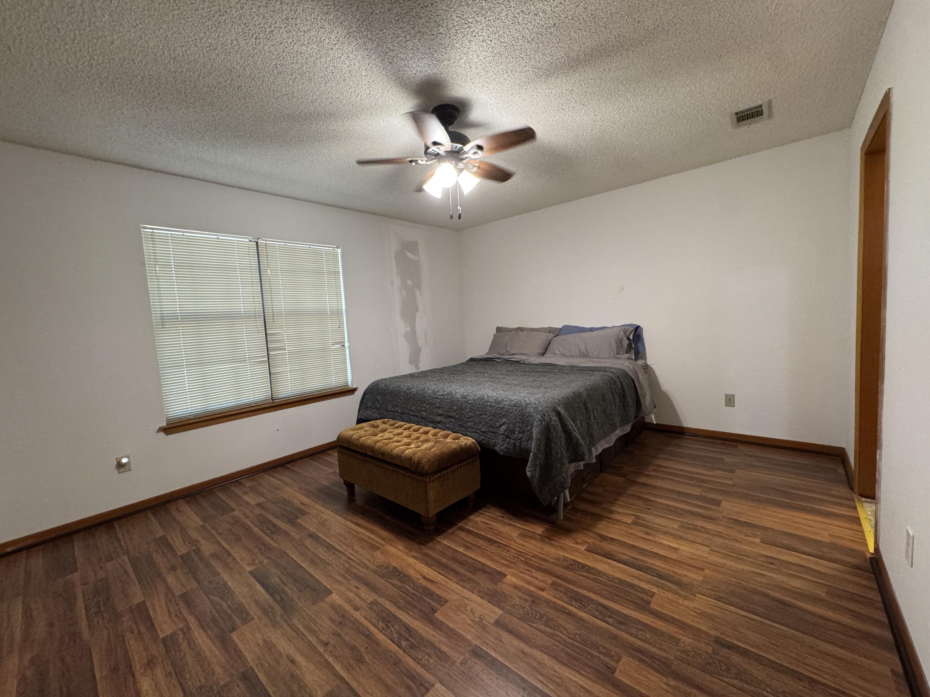 2928 Aplin Road Crestview, FL 32539 - Photo 15 of 42 a bedroom with a bed and a ceiling fan