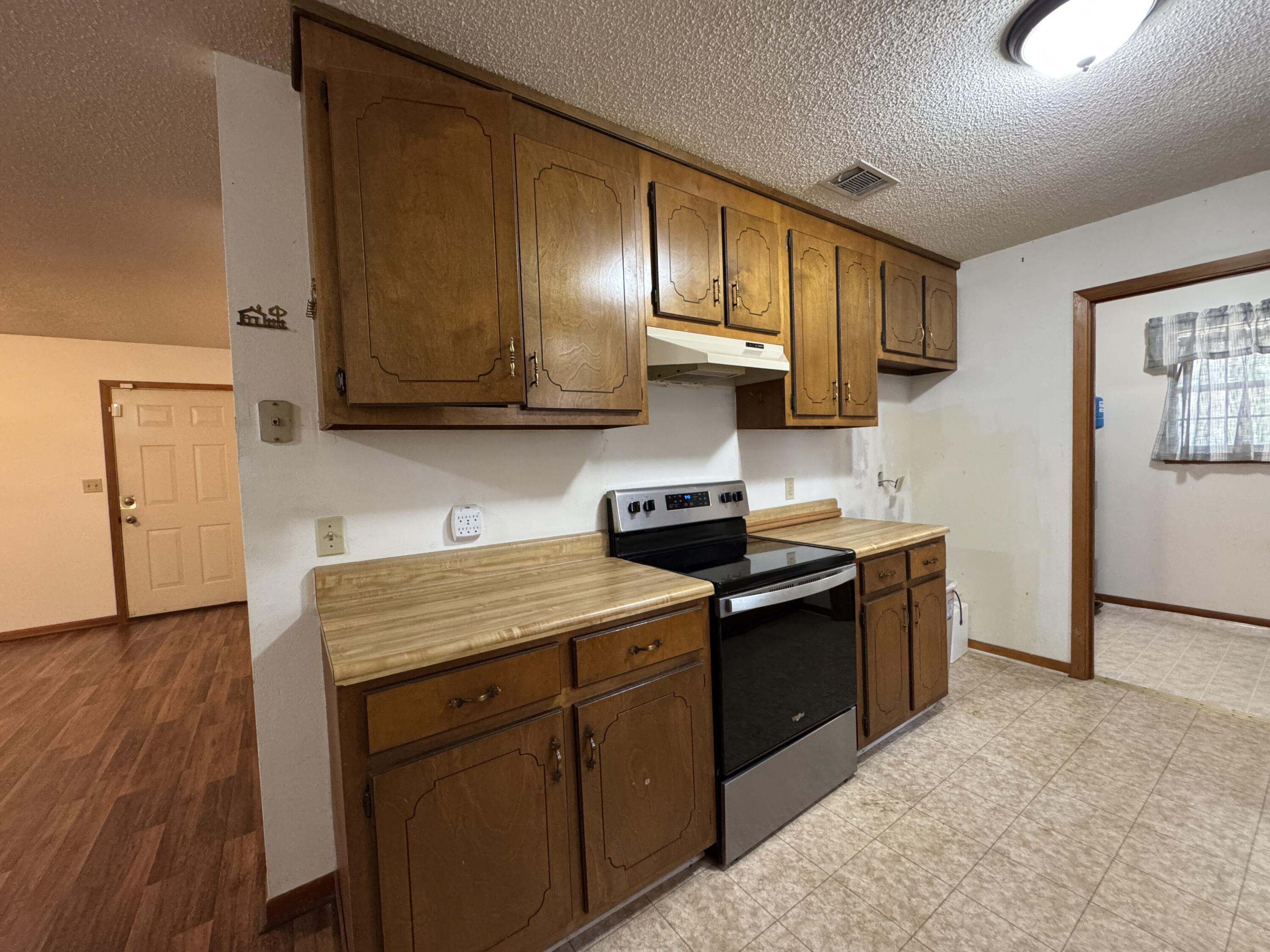2928 Aplin Road Crestview, FL 32539 - Photo 9 of 42 a kitchen with stainless steel appliances granite countertop a sink stove and cabinets