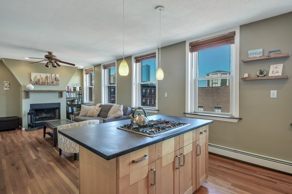 a view of kitchen island of a kitchen island wooden floor and living room view