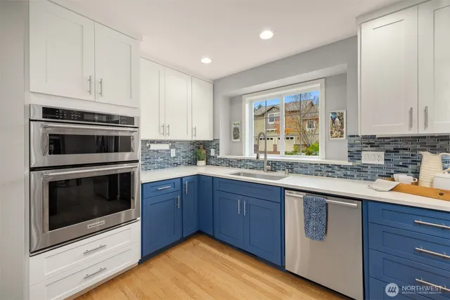 a kitchen with stainless steel appliances granite countertop a stove a sink and a microwave