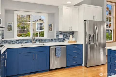 a kitchen with stainless steel appliances granite countertop a refrigerator and a sink