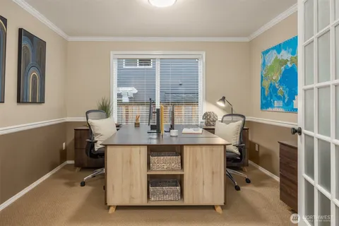 a view of a workspace with furniture and a window