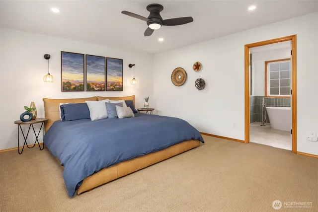 a bedroom with a large bed and a chandelier