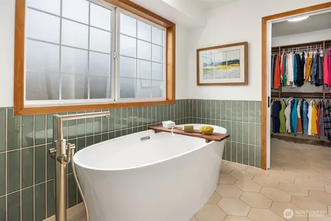 a bathroom with a bathtub and a window