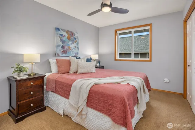 a bedroom with a bed and a painting on the wall