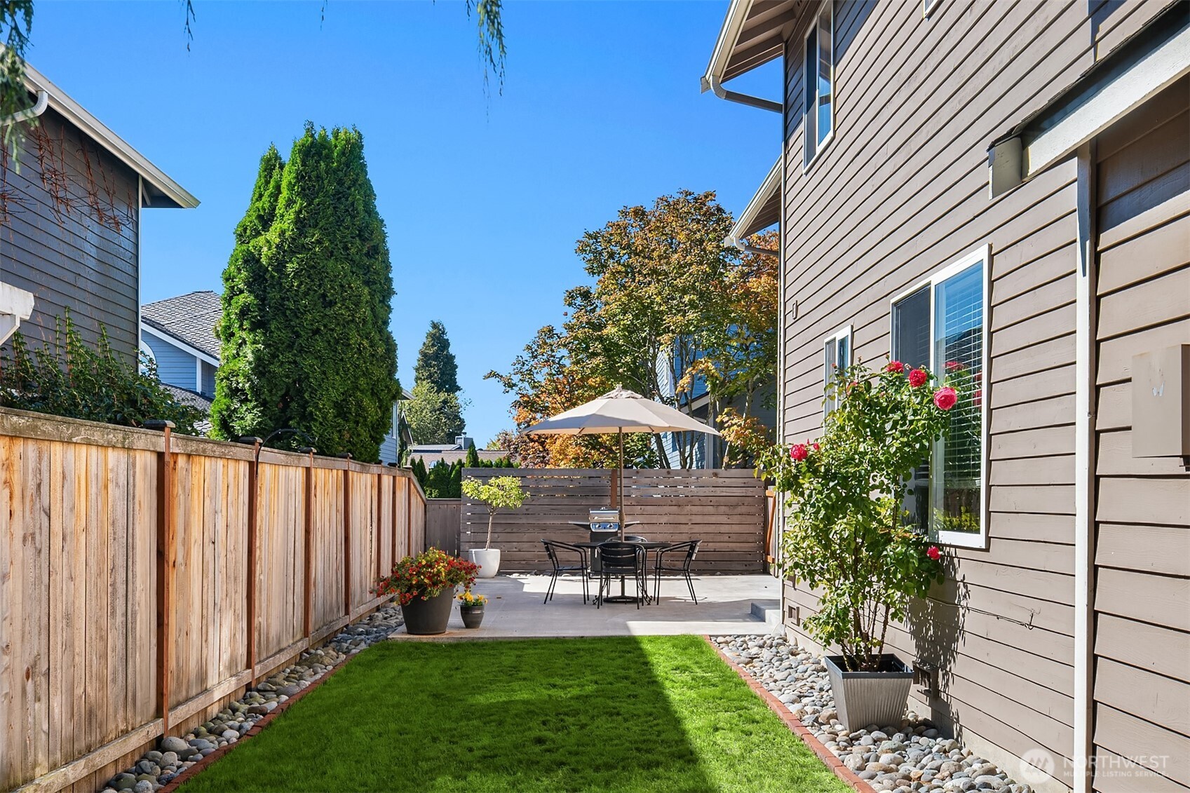 2714 182nd Place Southeast Bothell, WA 98012 - Photo 32 of 36 a patio with table and chairs and potted plants