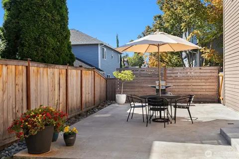 a view of a tables and chairs under an umbrella in patio