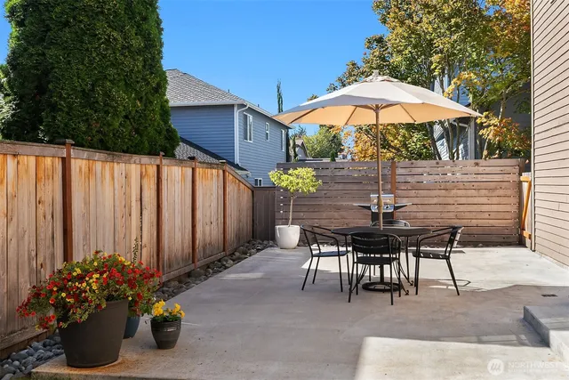 a view of a tables and chairs under an umbrella in patio