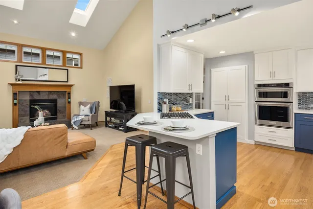 a view of a livingroom with furniture a fireplace and wooden floor