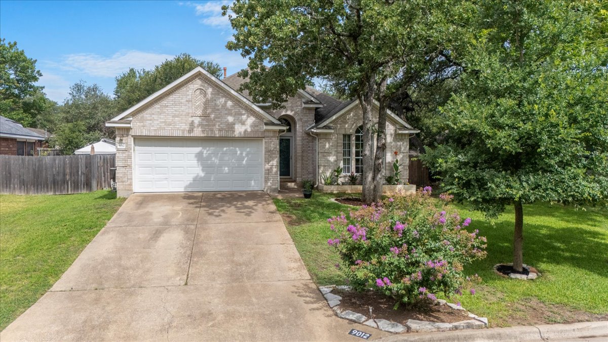 9012 Meacham Way Austin, TX 78749 - Photo 3 of 34 Light-colored brick exterior with an attached two-car garage