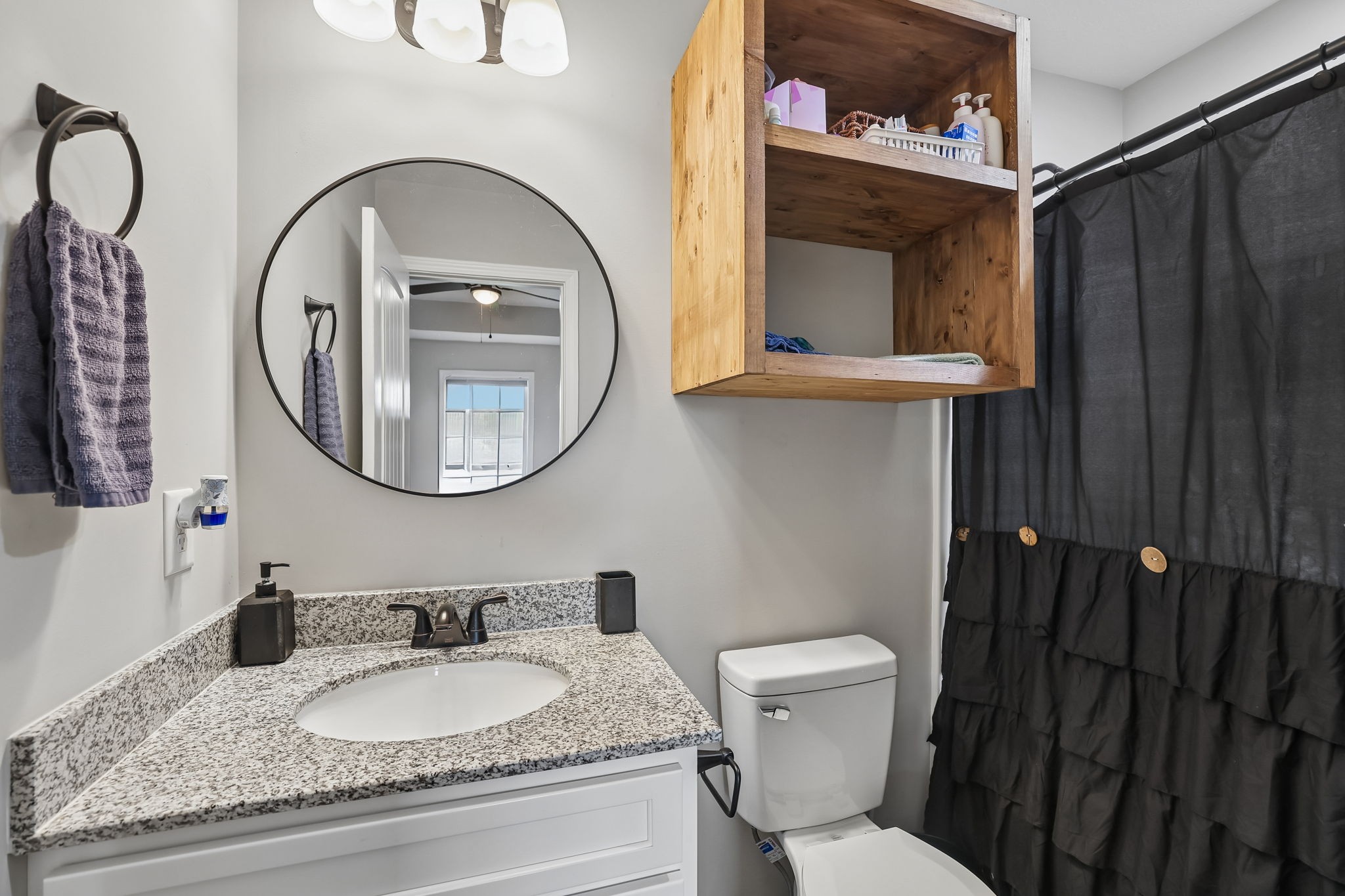 1715 Old Belfast Road Lewisburg, TN 37091 - Photo 27 of 42 a bathroom with a granite countertop toilet a sink and a mirror