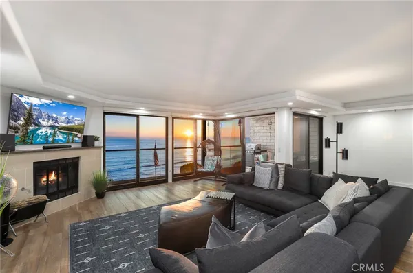 a living room with furniture a flat screen tv and a fireplace