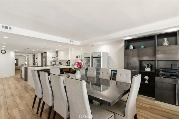 a dining room with furniture and wooden floor