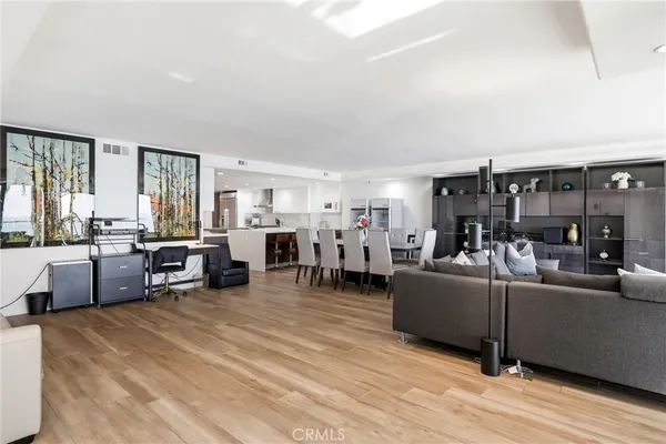 a living room with lots of furniture and kitchen view